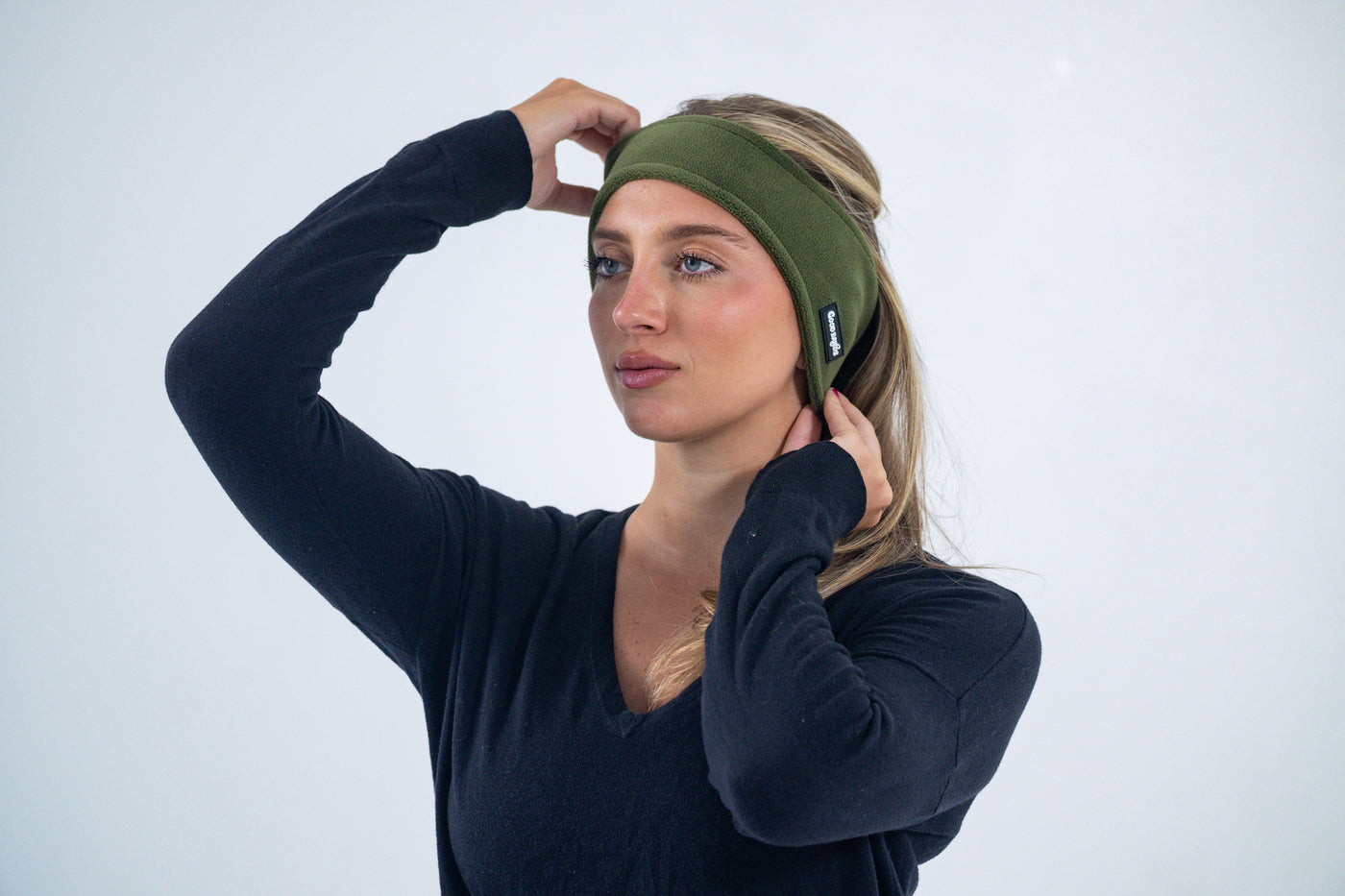Pulling on a fleece ear warmer headband so it fully covers the ears