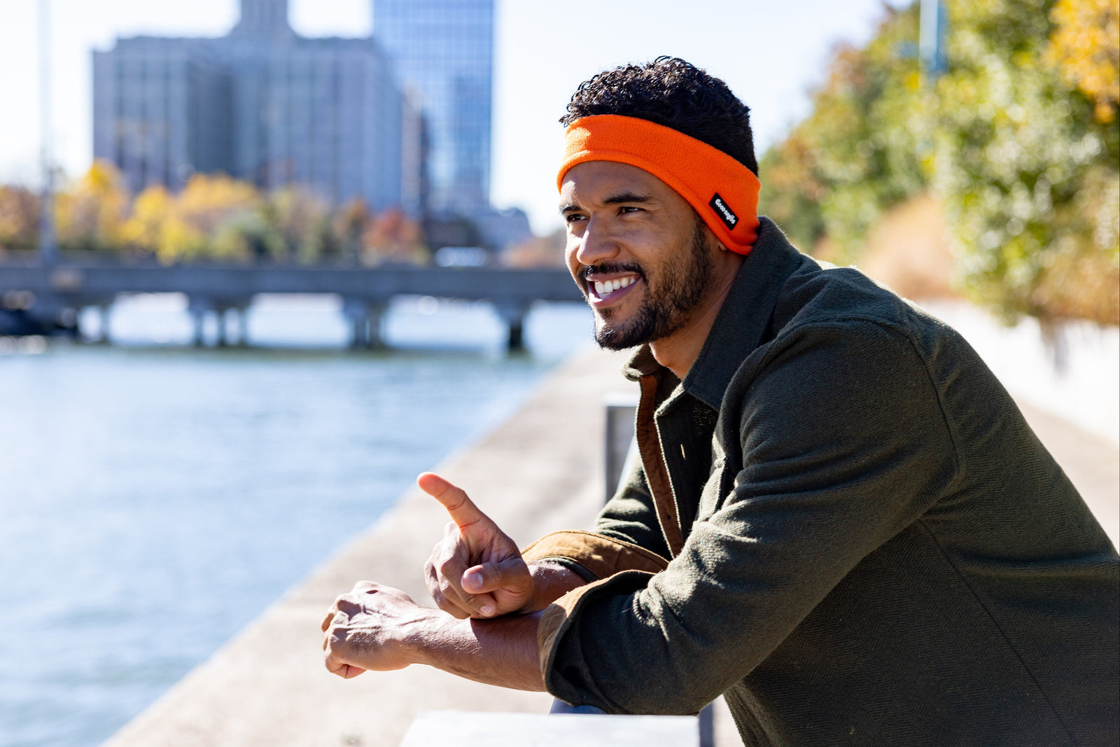 Orange winter ear warmer headband worn by a runner on a cold morning by the water
